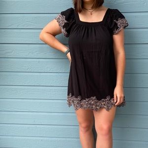 Black mini dress with white detailing.